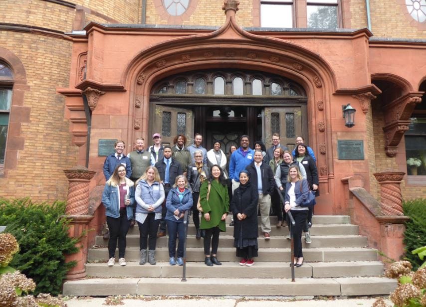 Group photo of staff and residents at facility entrance