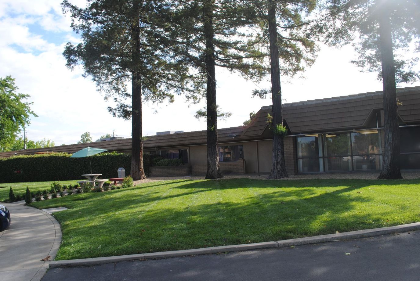 Exterior view of Crestwood Behavioral Health with trees and grass