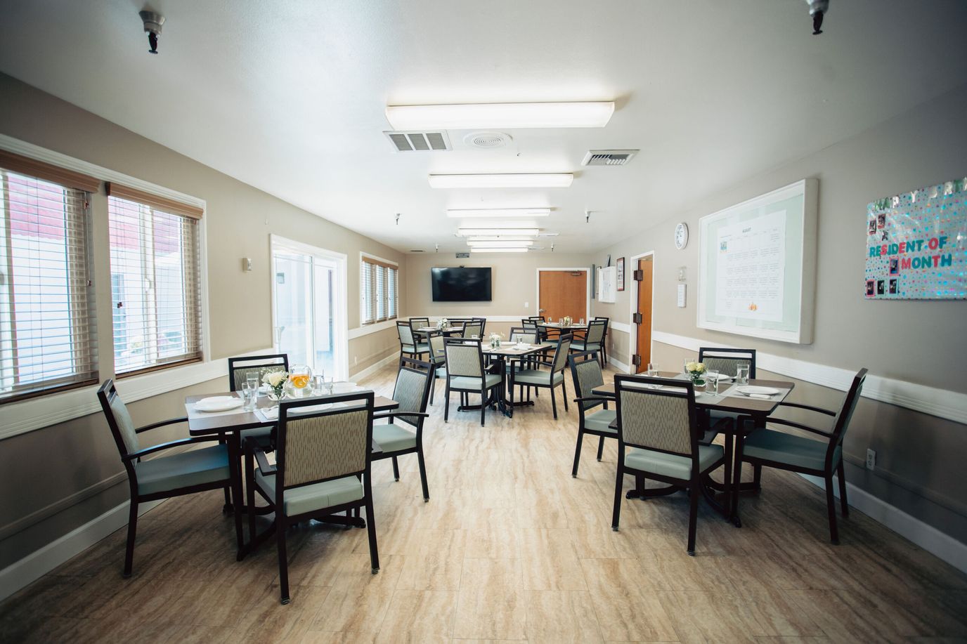 Well-lit dining area with tables and chairs