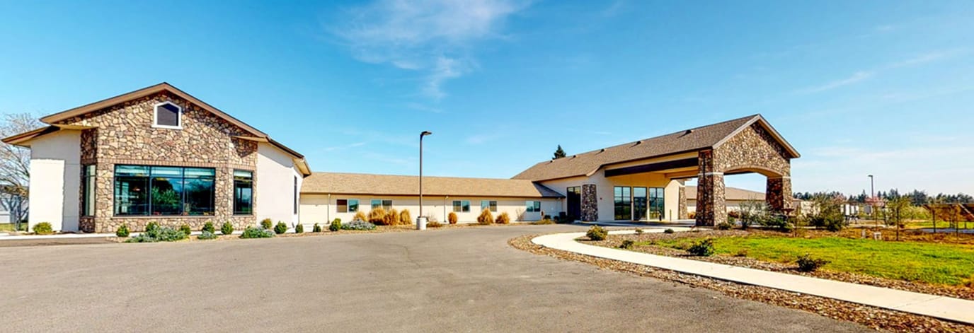 Exterior view of Emerald Oaks facility with landscaping