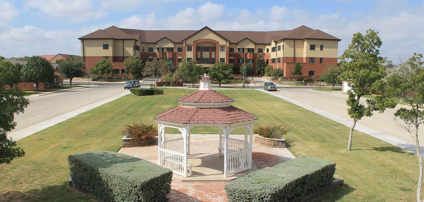 Outdoor view of the facility with gazebo and building in background