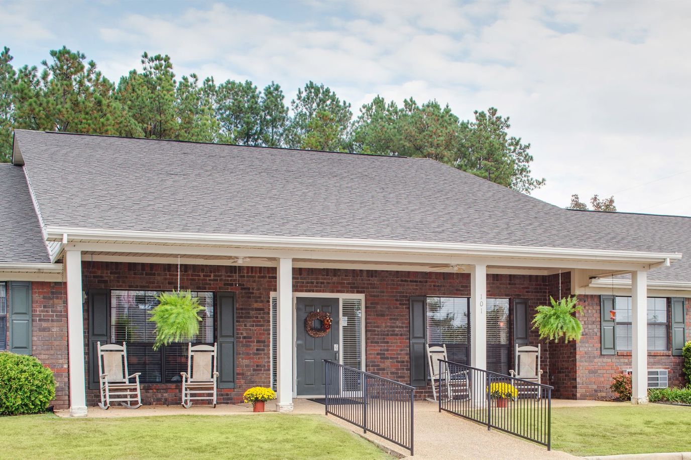Exterior view of the facility with rocking chairs and a porch