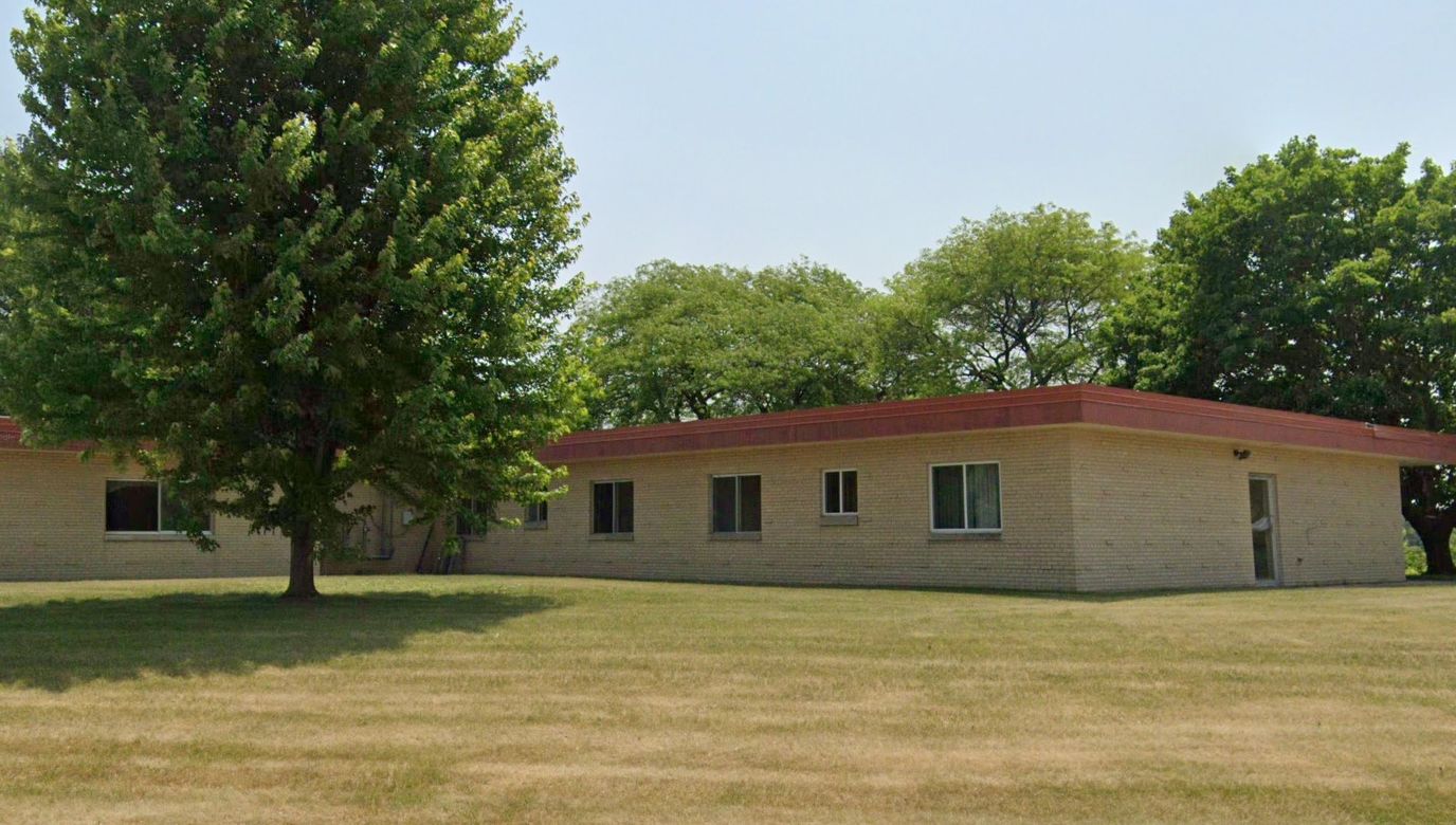 Exterior view of the Meadowbrook facility surrounded by trees