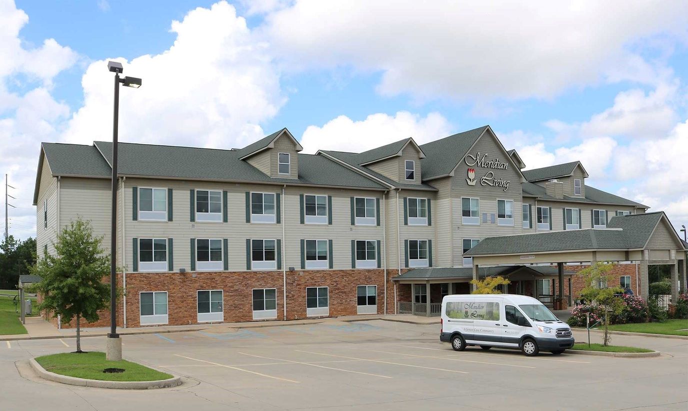 Exterior view of the facility building with a van