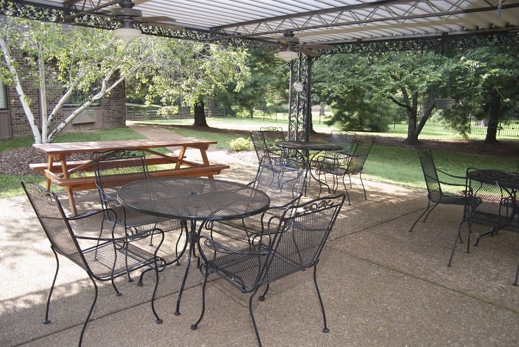 Outdoor seating area with tables and chairs