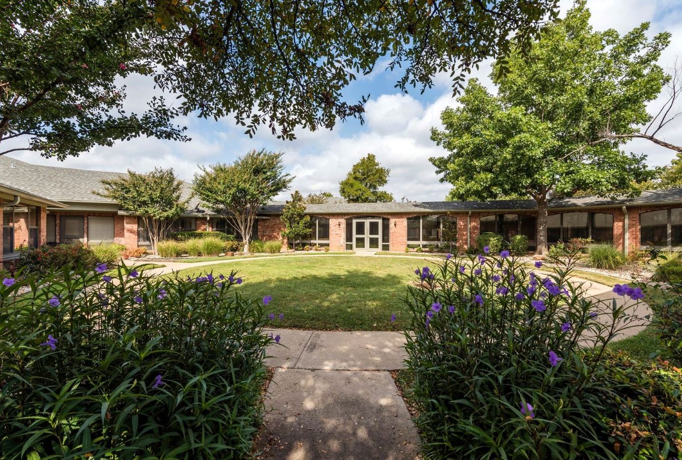Outdoor view of landscaped courtyard with pathways and flowers