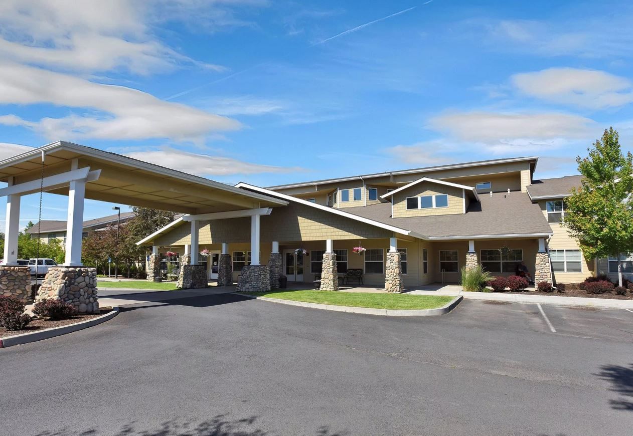Exterior view of a senior living facility with covered entrance