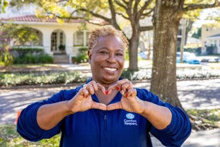 Staff member making a heart shape outdoors