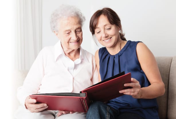 Resident and caregiver sharing a photo album