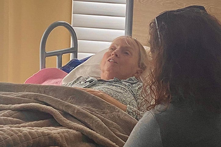 Resident interacting with a staff member in a care room