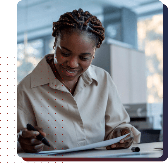 A woman working at a desk with papers
