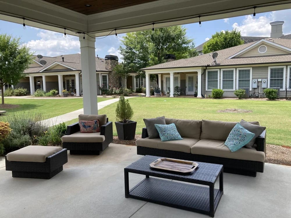 Outdoor seating area with comfortable couches and garden views