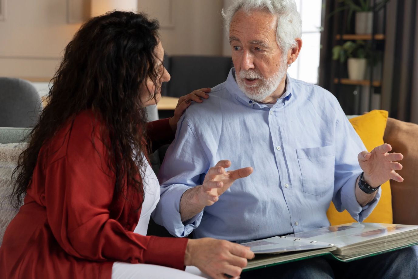 Caregiver interacting with senior resident in a cozy living room