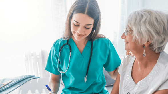Healthcare worker with senior resident in a care setting.