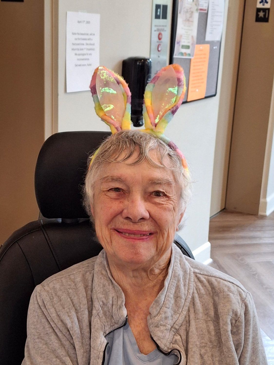 Vivera Senior Living of Jeffersonville, assisted living in Jeffersonville, IN — Elderly woman wearing colorful bunny ears in a common area