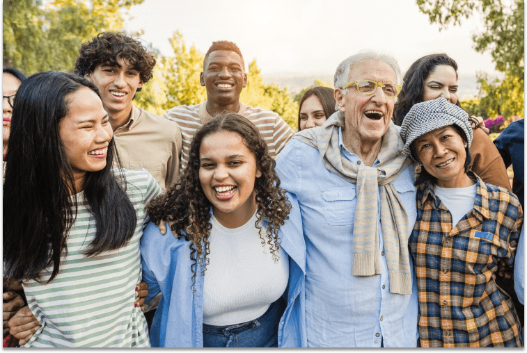 Group of joyful seniors and caregivers outdoors