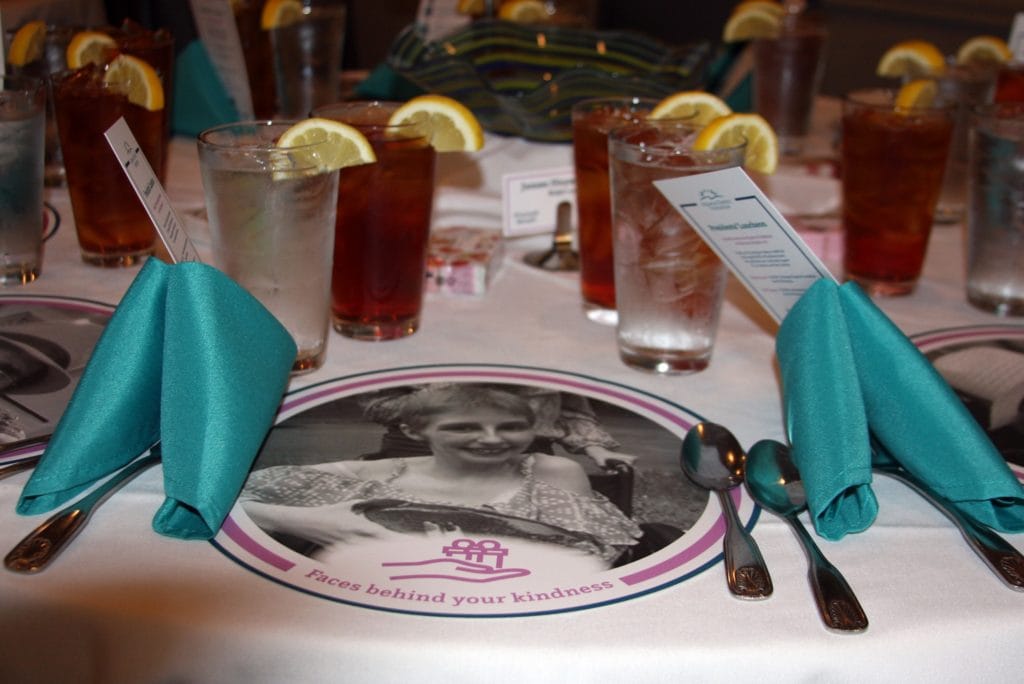 Table setting with drinks and decorative menus.