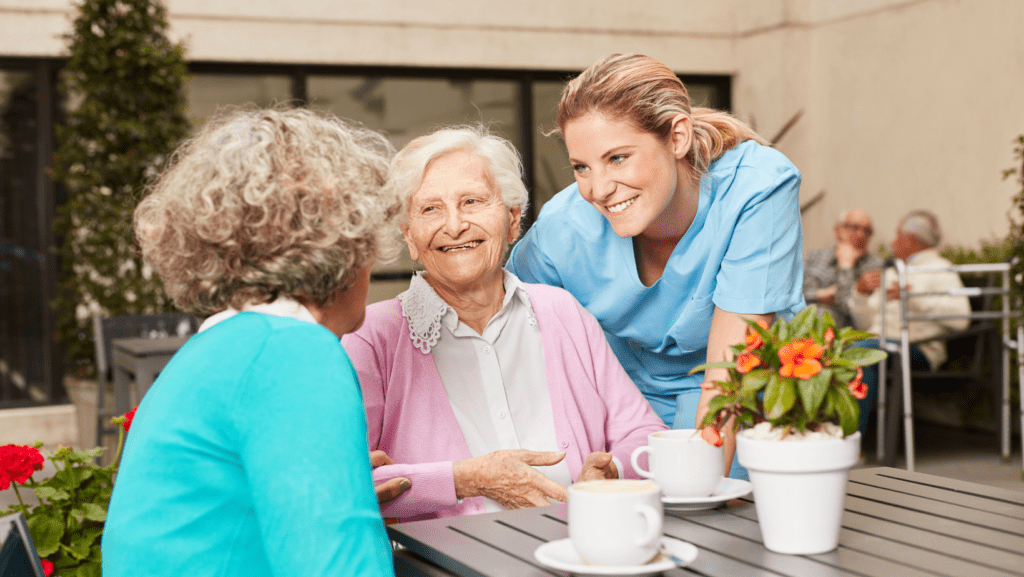 All Heart Homecare – New York, home care in New York, NY — Seniors enjoying conversation with a caregiver in a garden