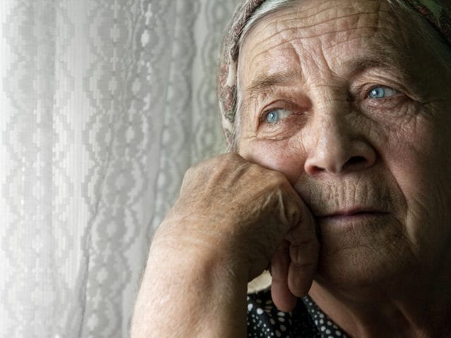 Serenity Hospice Care, hospice home in Columbus, GA — Elderly woman gazing thoughtfully by a window