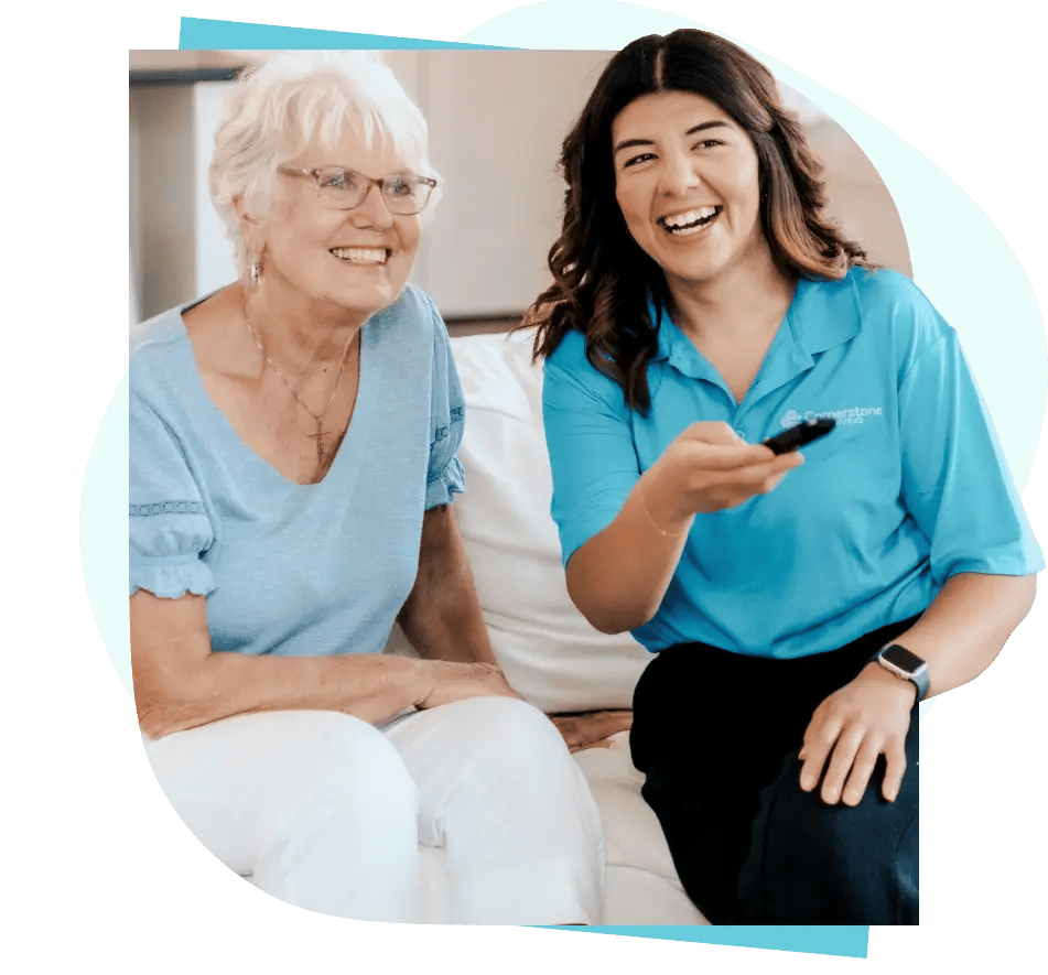 A resident and caregiver sharing a joyful moment indoors