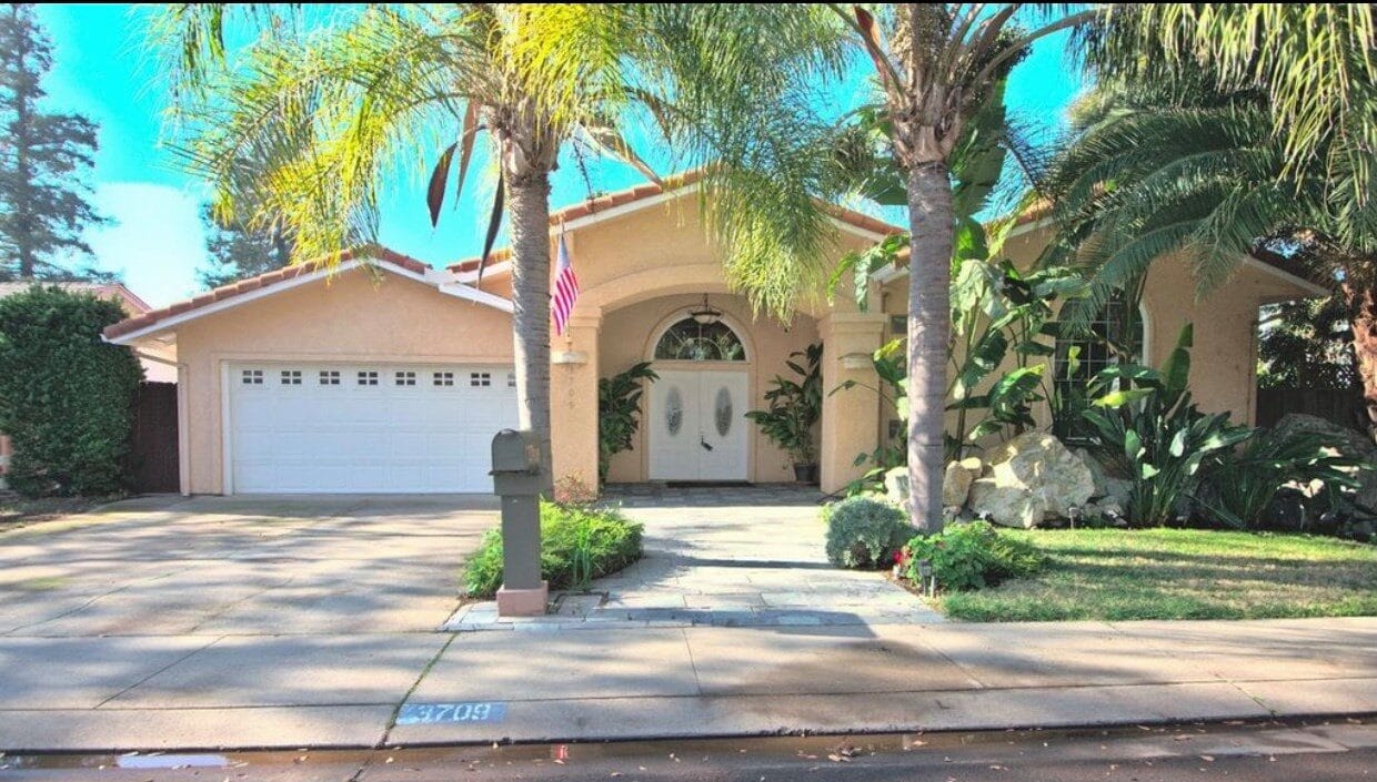 Exterior view of a welcoming residential building with palm trees