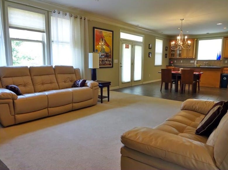 Cozy living room with beige sofas and dining area
