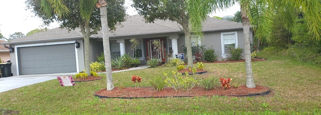 Exterior view of a senior living facility with landscaped yard