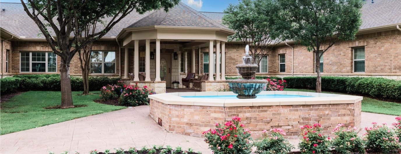 Beautiful outdoor garden area with a fountain and seating