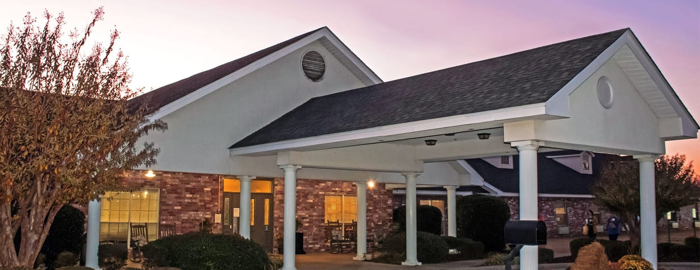 Front entrance of a nursing home facility at twilight