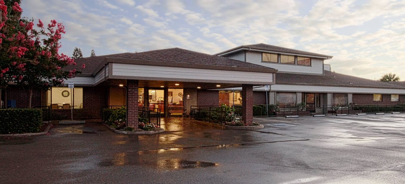 Exterior view of Pine Creek Care Center with landscaped areas