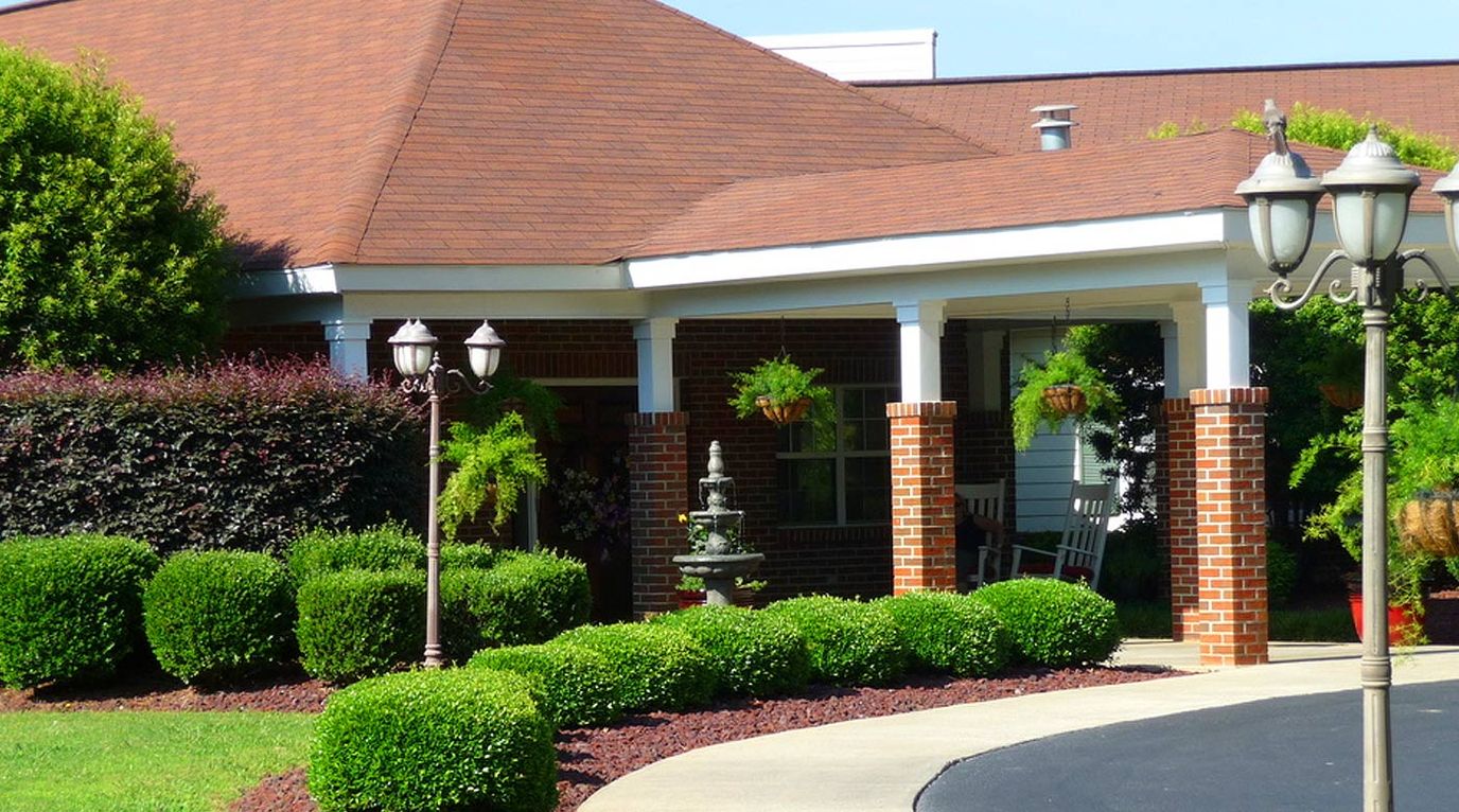 Entrance to Autumn Cove Assisted Living with landscaping
