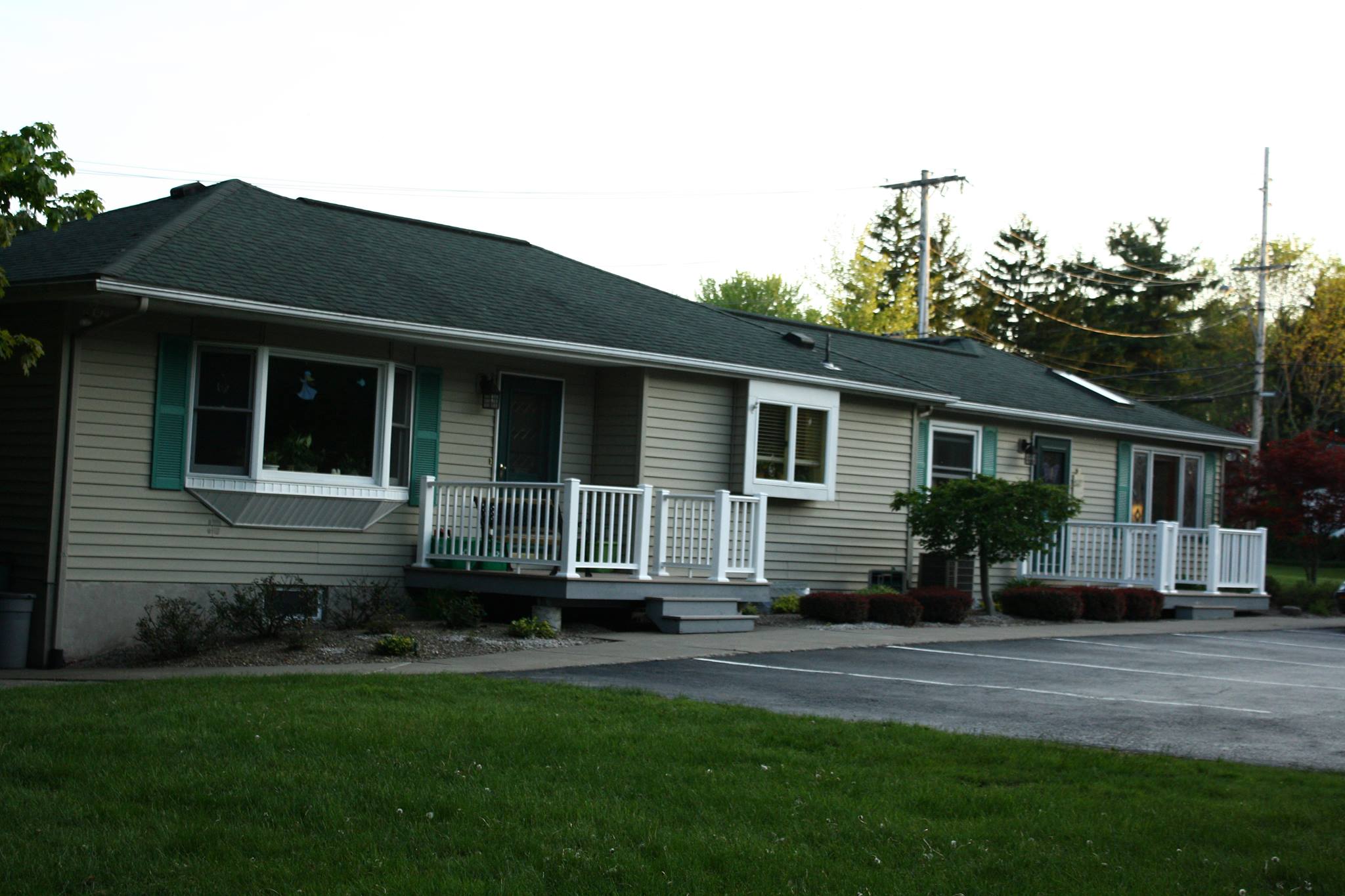 Exterior view of a senior living facility with porches