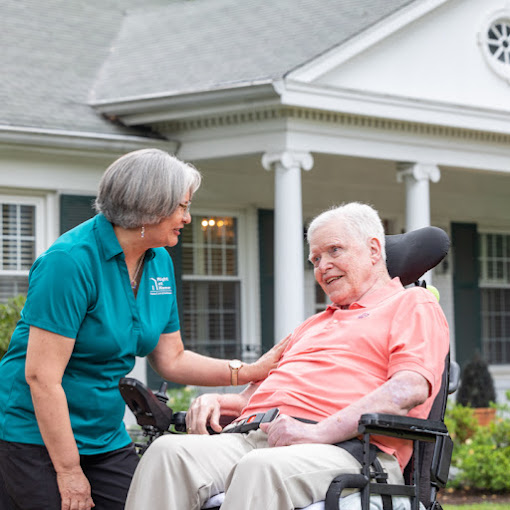 Staff member interacting with a resident outdoors