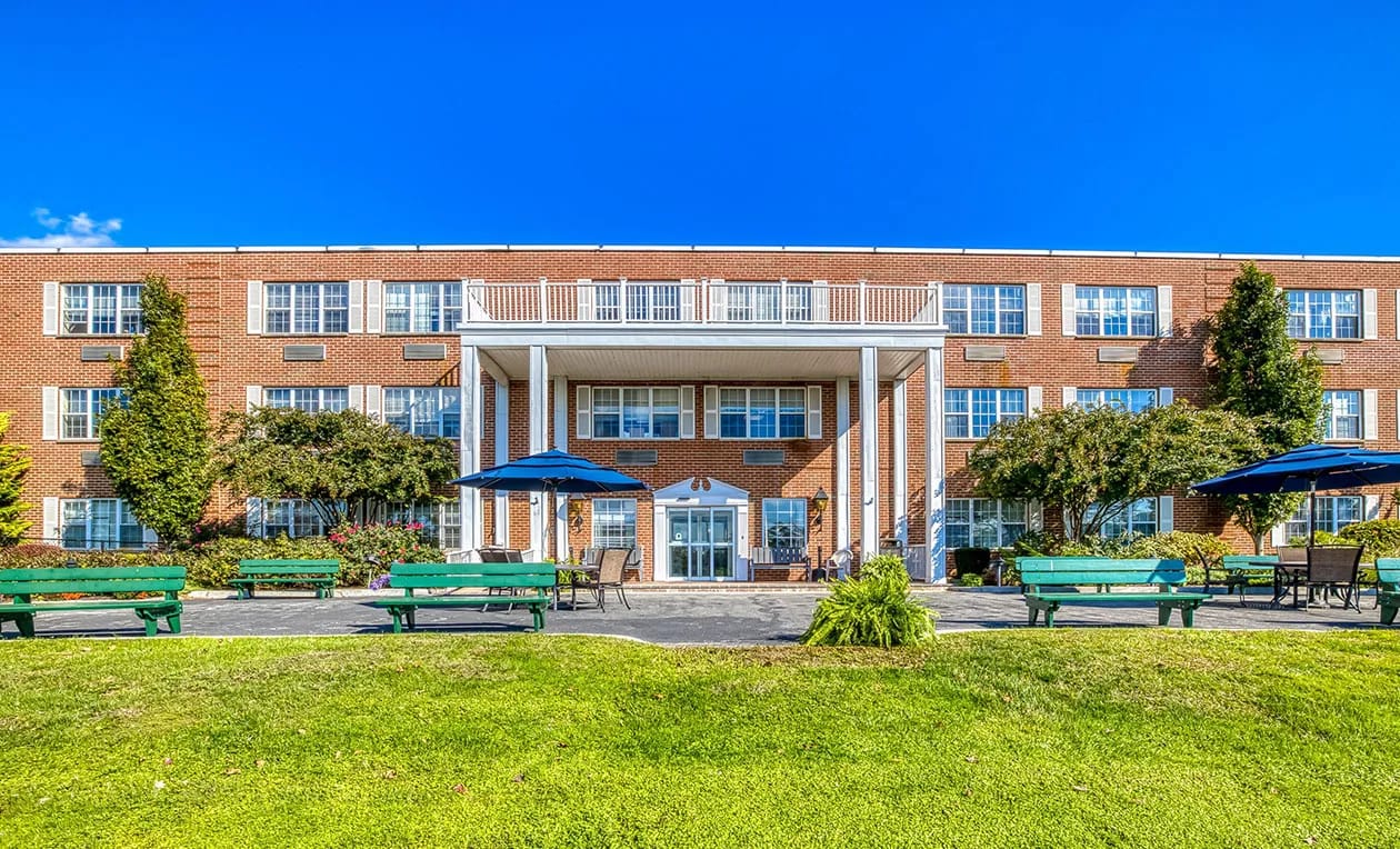 Exterior view of Lake Shore Assisted Living Residence with outdoor seating