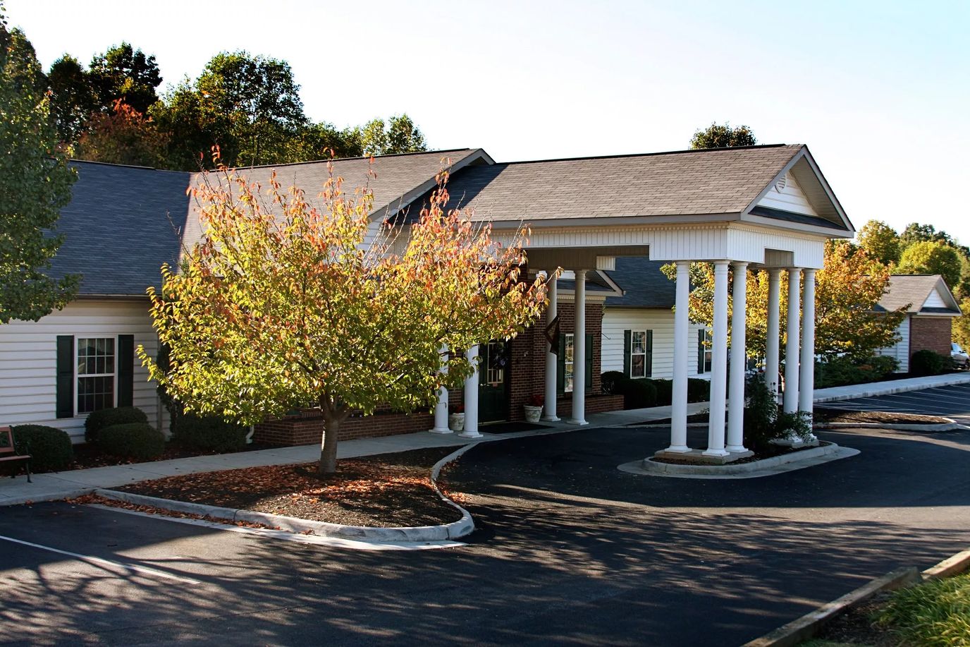 Exterior view of assisted living facility with trees