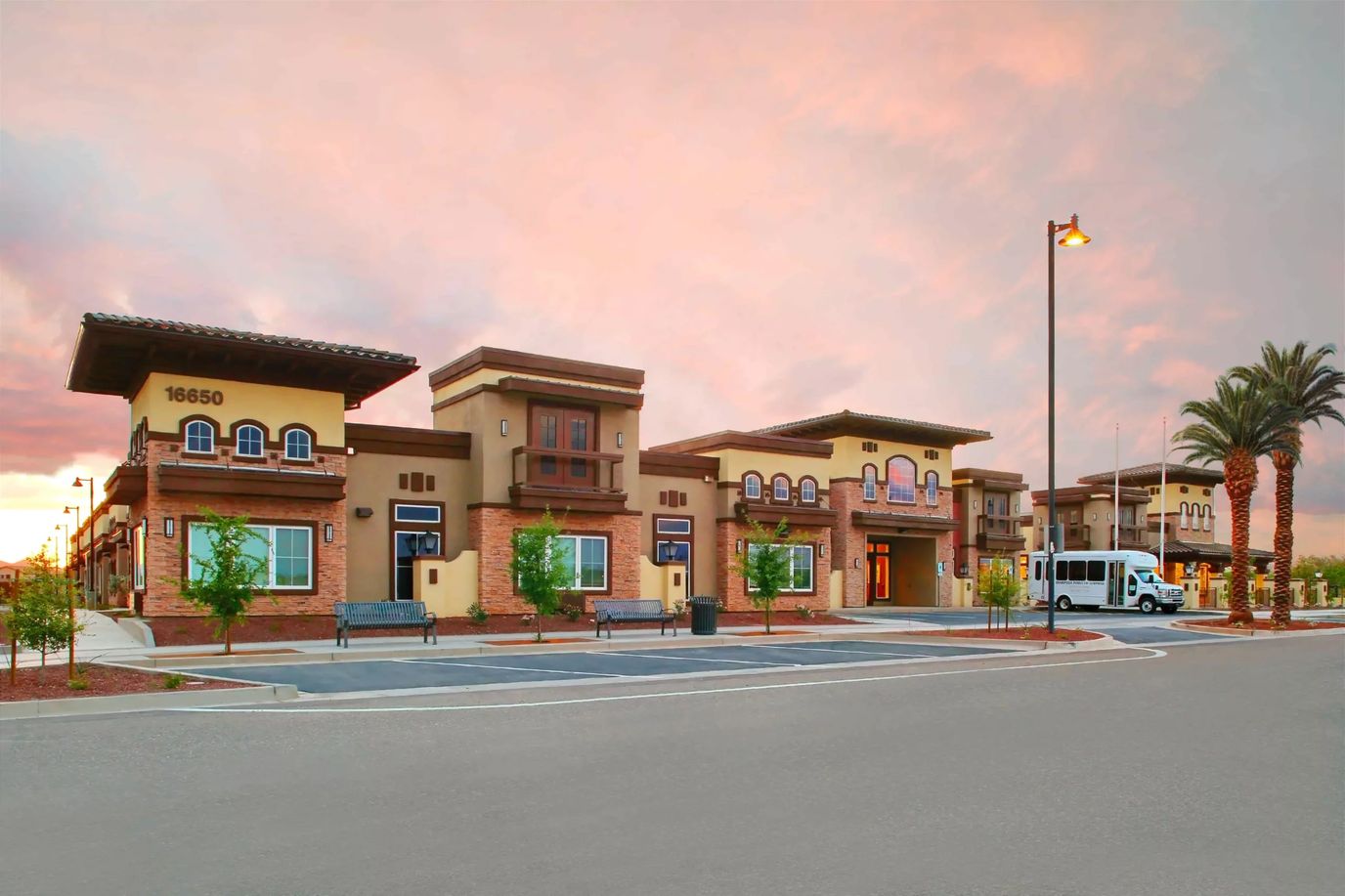Exterior view of the senior living facility at sunset