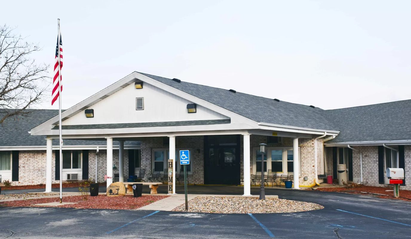 Exterior view of a senior living facility with a landscaped entrance