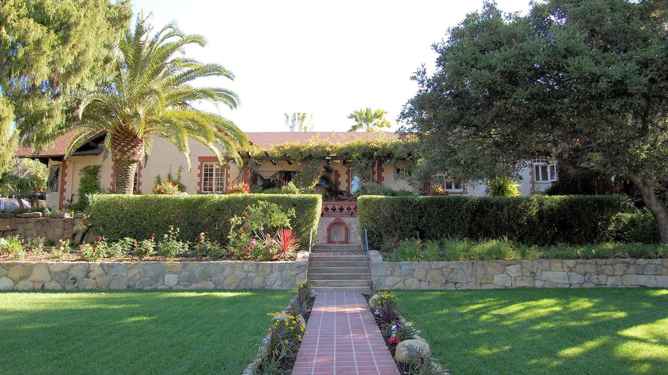 Exterior view of a senior living building with gardens