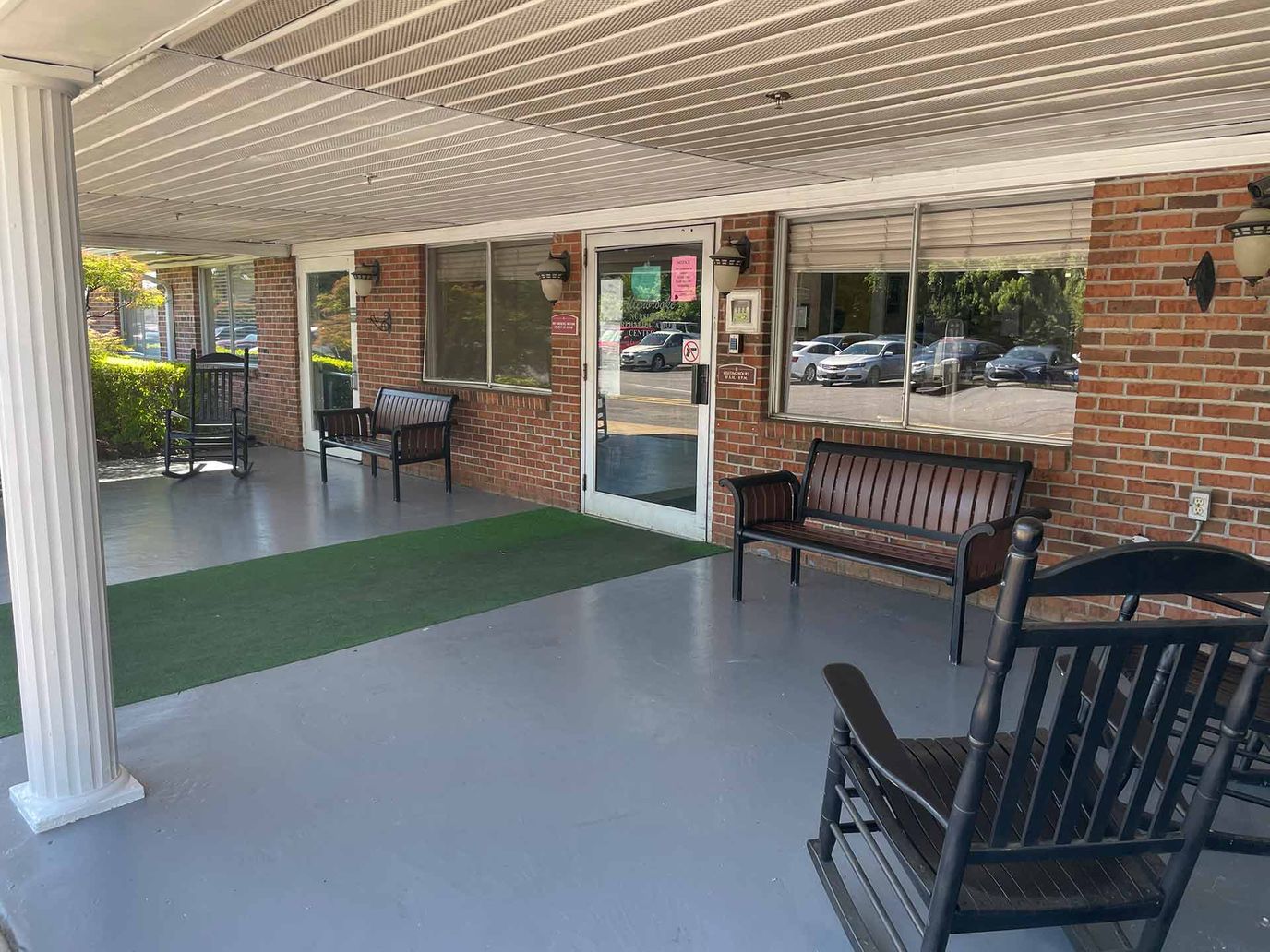 Covered porch area with seating outside the facility