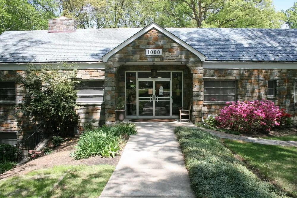 Exterior view of a nursing home with landscaped path