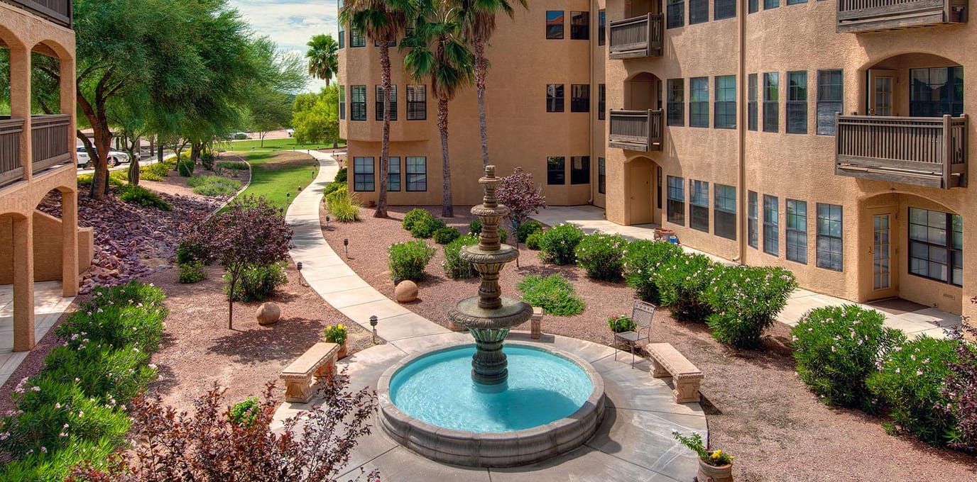 Outdoor courtyard with a fountain and landscaped areas