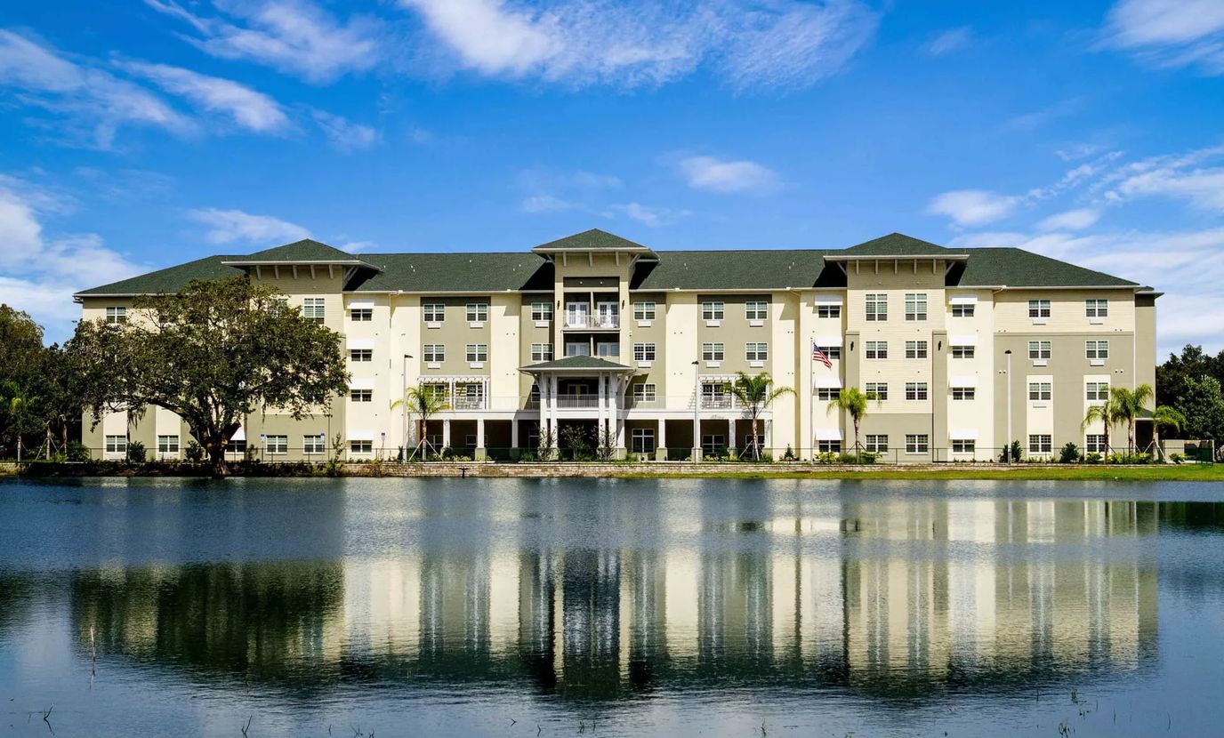 Exterior view of Arbor Hills facility by the water