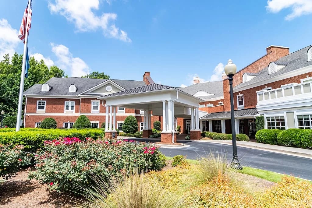 Exterior view of a senior living facility with landscaping
