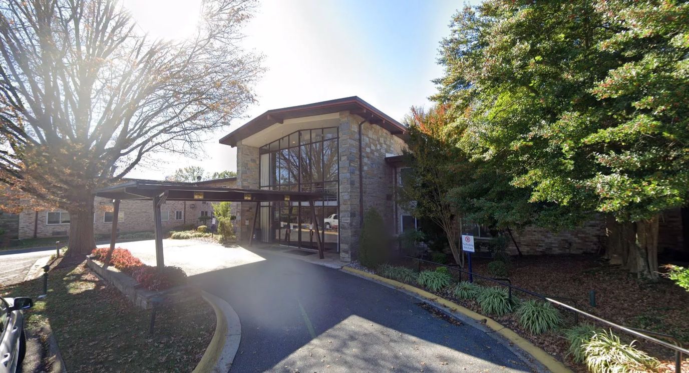Entrance of a senior living facility with landscaping