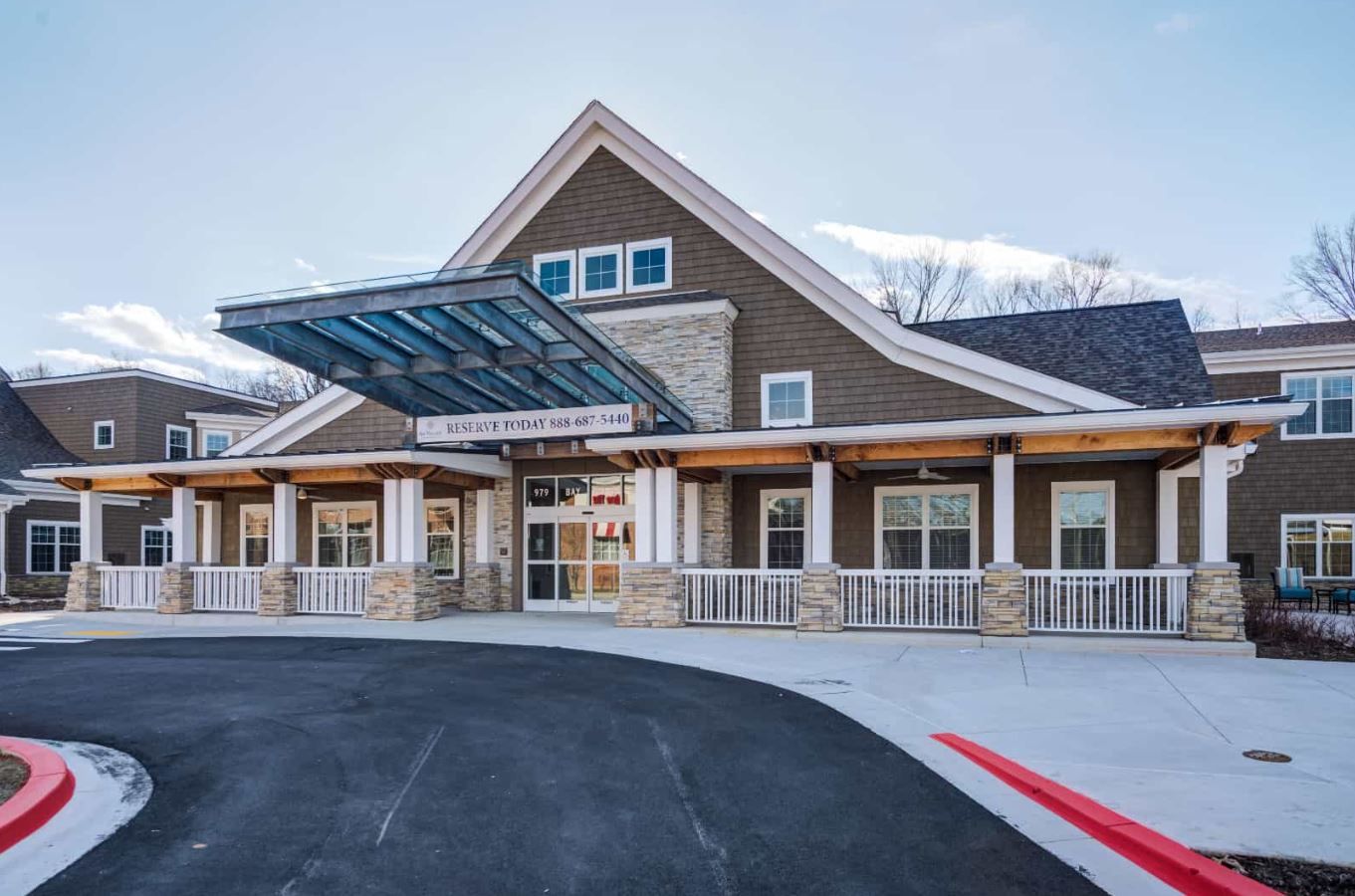 Exterior view of a senior living facility with a covered entrance