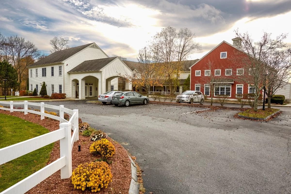 Exterior view of a senior living facility with gardens