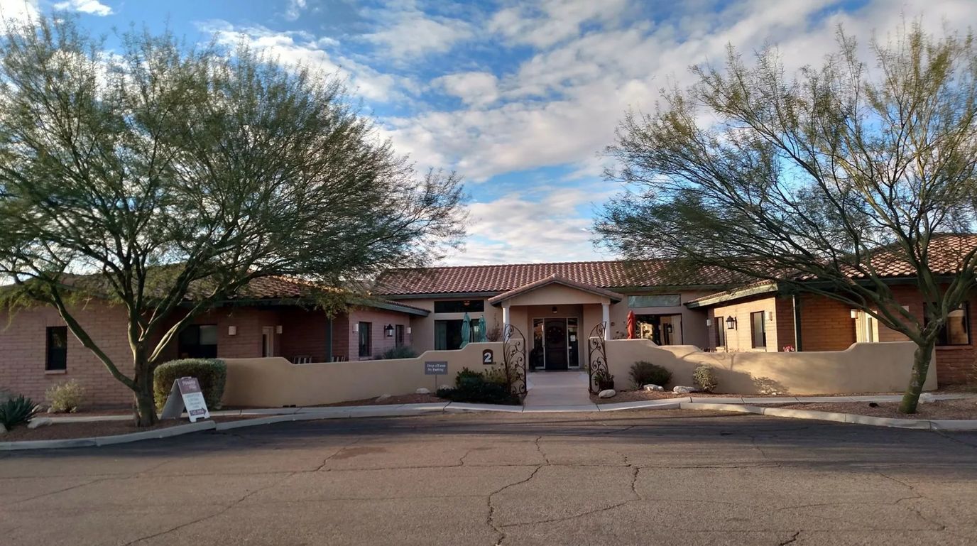 Exterior view of the assisted living facility with desert landscape