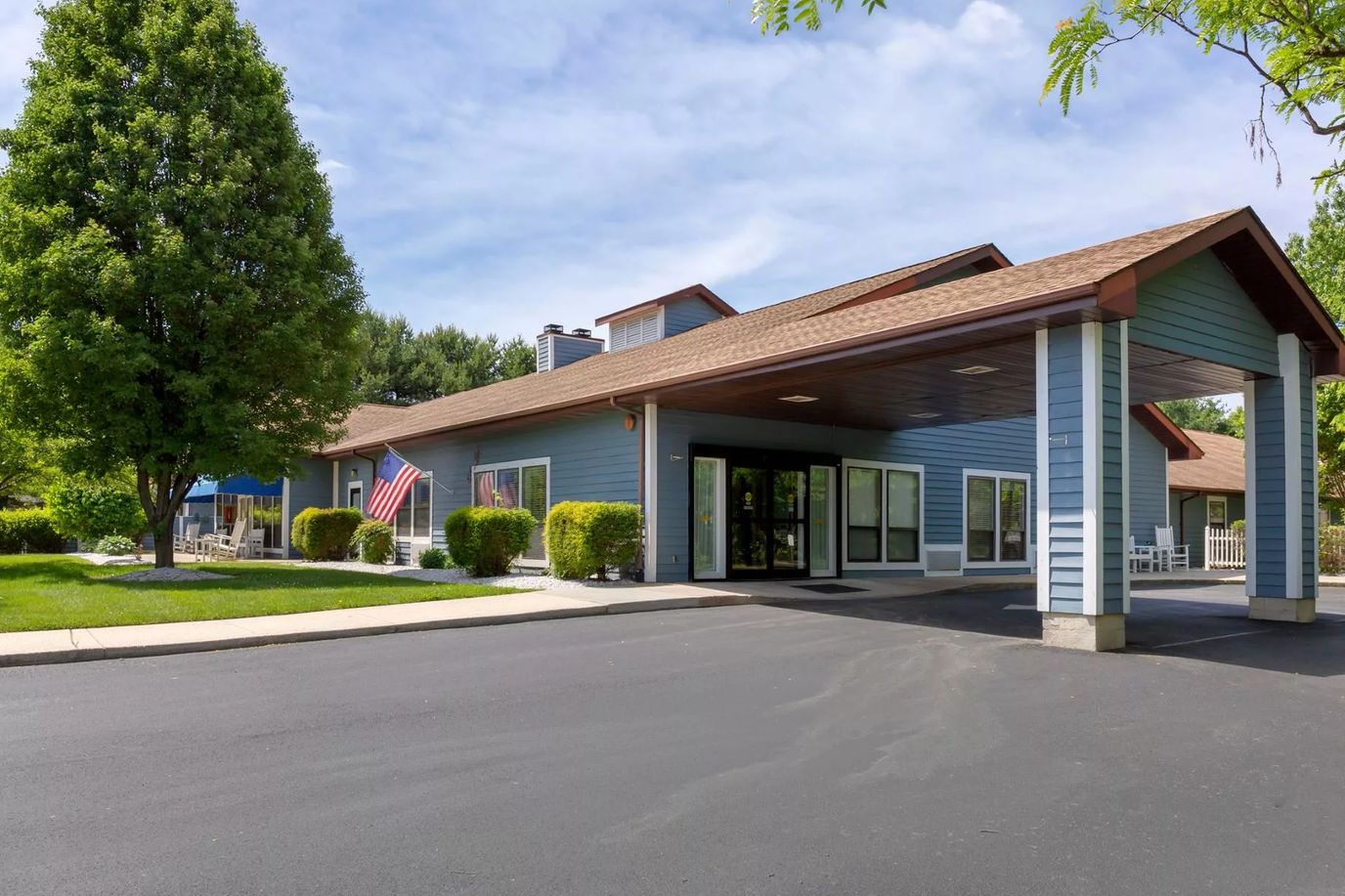 Exterior view of a senior living facility with greenery