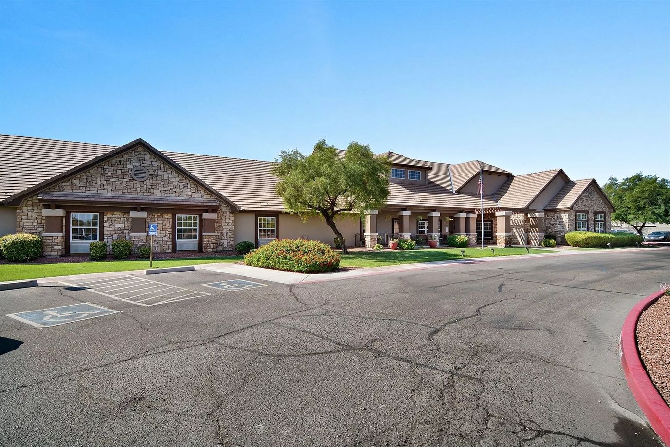 Building exterior of a senior living facility with a garden