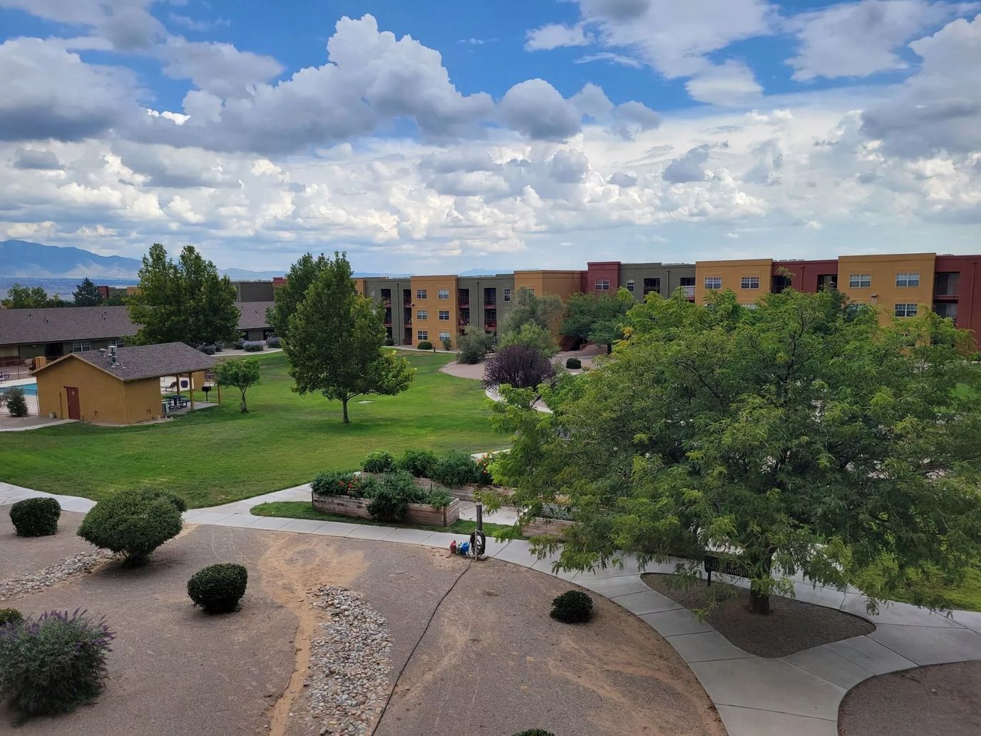 A landscaped outdoor space with pathways and buildings